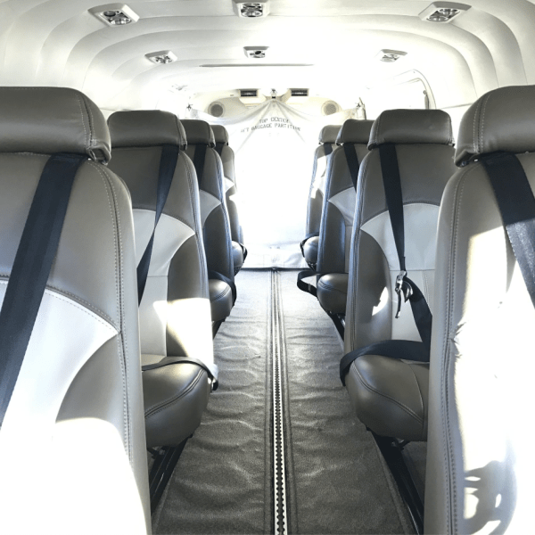View of interior seating of plane looking down the row